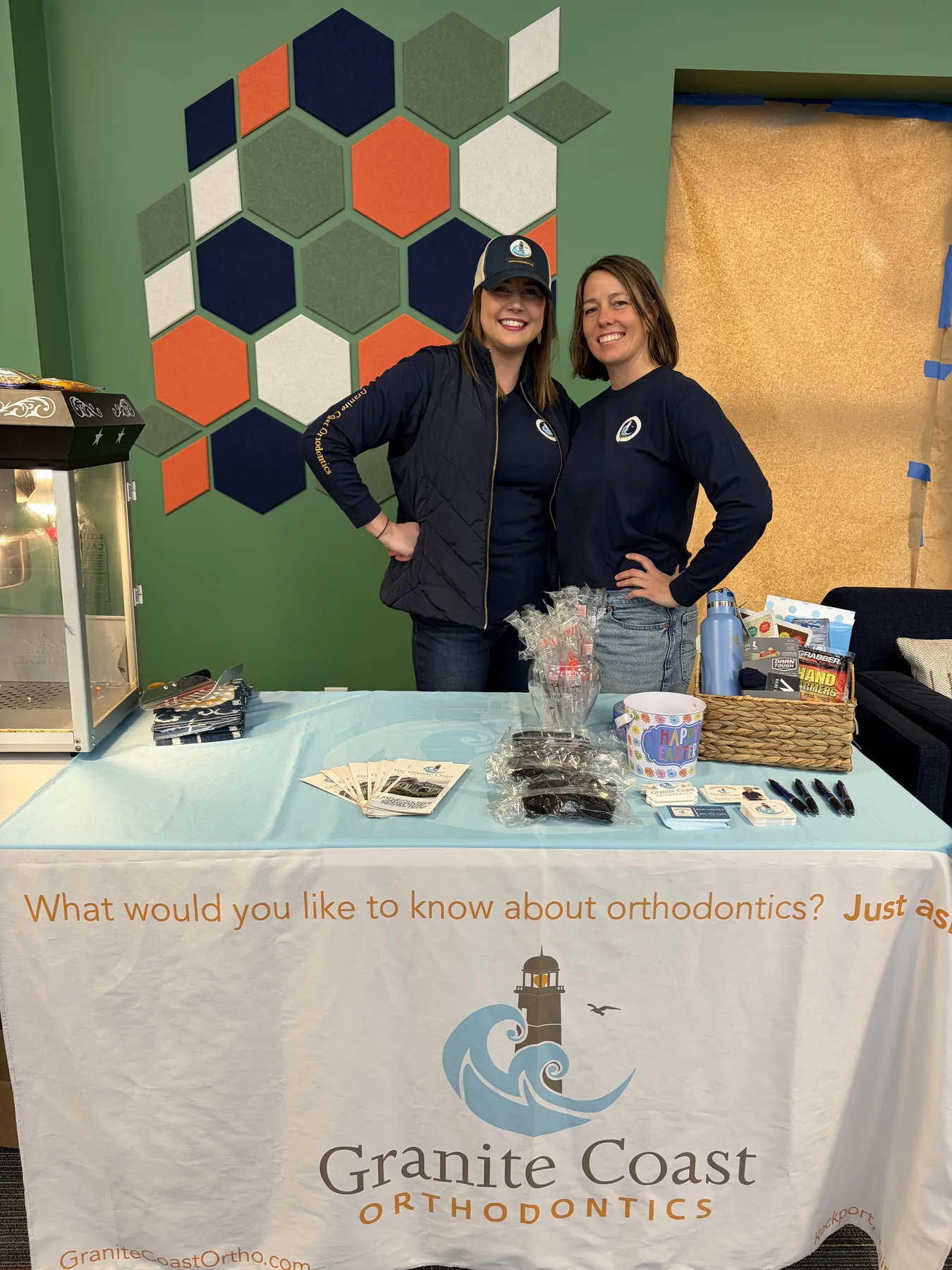 Granite Coast Orthodontics team members at a community event table