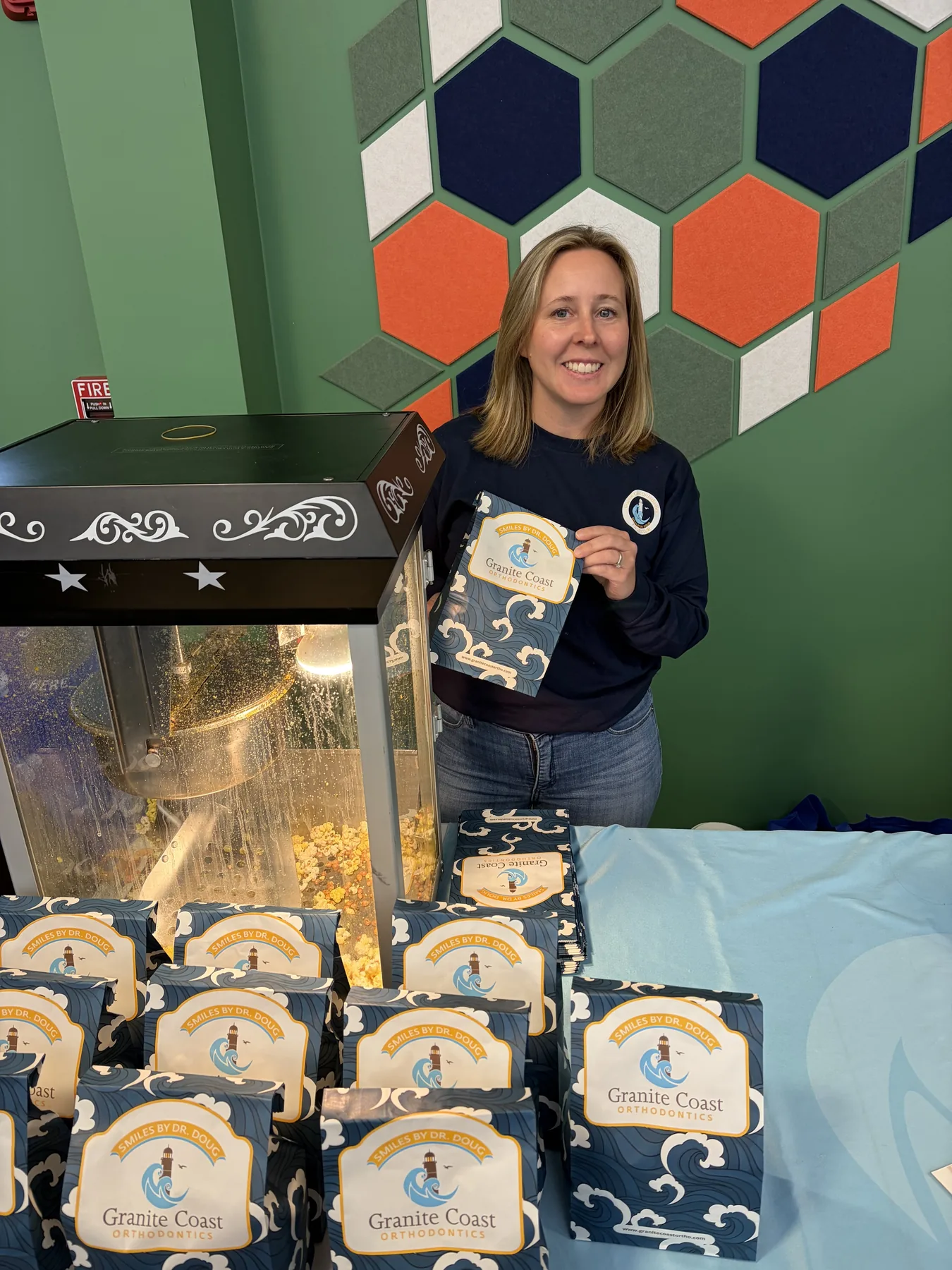 Granite Coast Orthodontics popcorn bags at a community booth