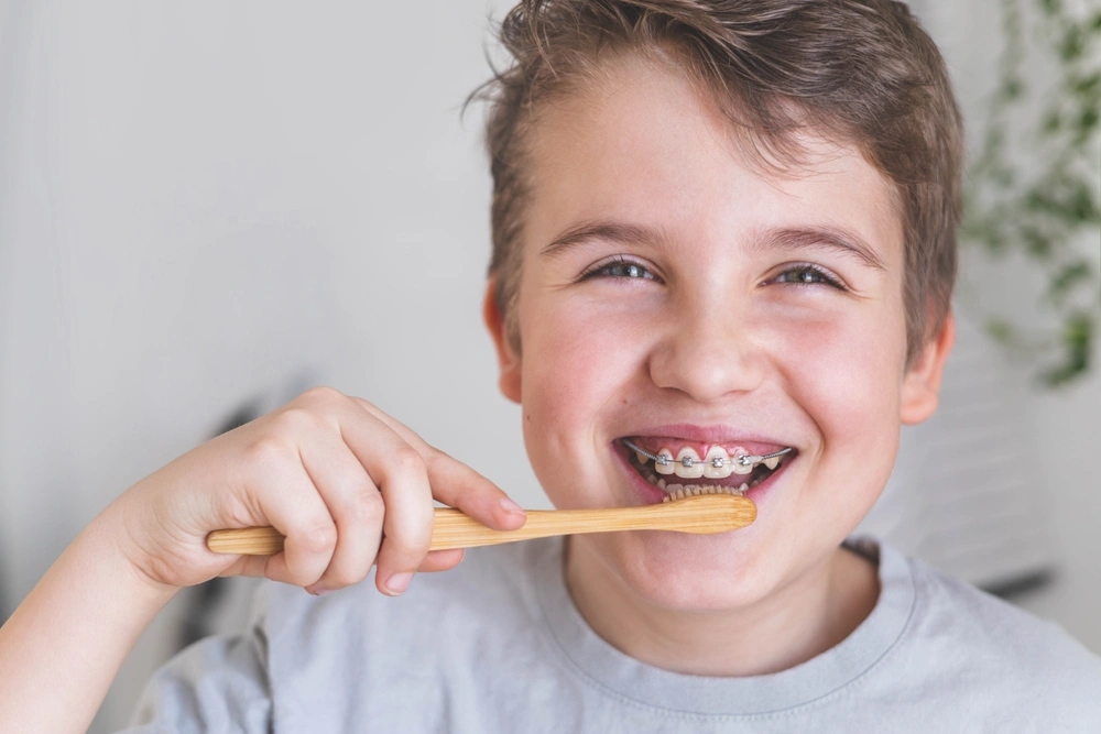 Child brushing teeth with braces