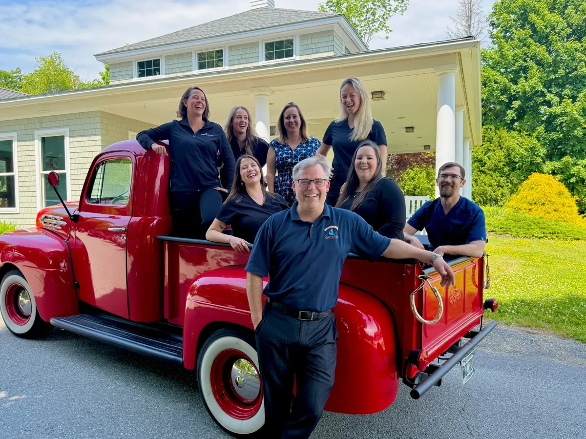 Granite Coast Orthodontics team in front of a red truck